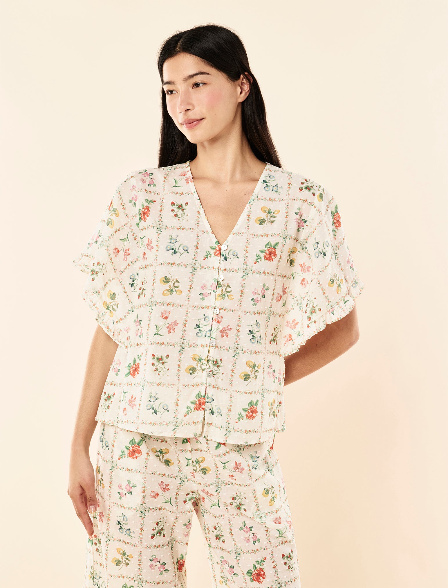 Zoey wearing the Evie Frill Short Sleeve Top
[model: Zoey wears size XS |  Height: 172cm/ 5’7” | Bust: 80cm | Waist: 62cm | Hips: 89.5cm]