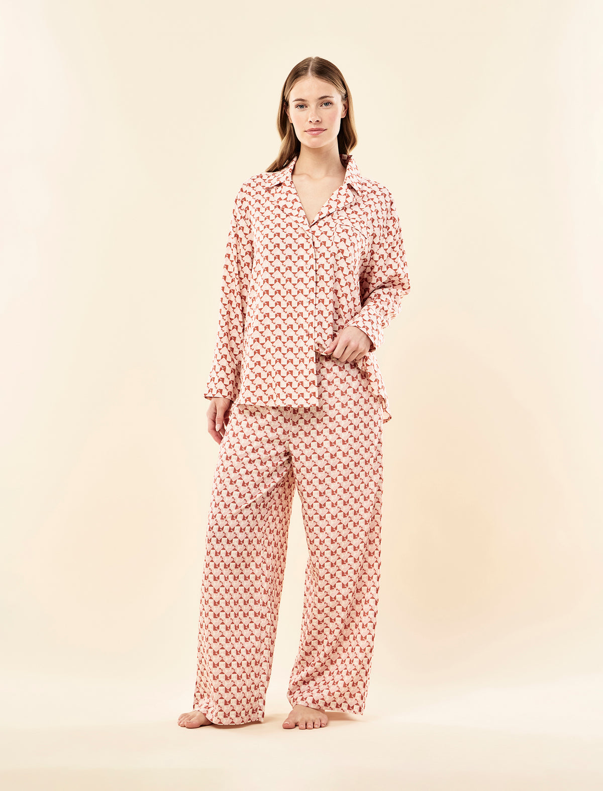 Sianie wearing the Karen Walker Monogram Tiles Relaxed Full Length PJ Set
[model: Sianie wears size S |  Height: 175m
/ 5’9” | Bust: 85cm | Waist: 66cm| Hips: 93cm]